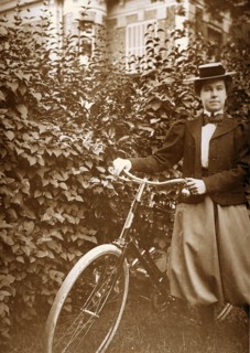 French woman standing with a bicycle