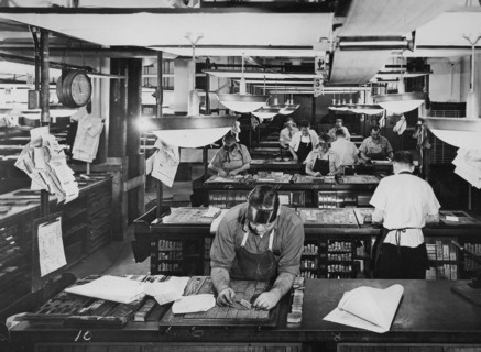 Typesetters and compositors put lead characters and letters into blocks for use in newspaper printing. American circa 1945