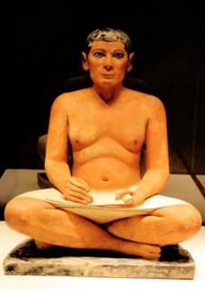 Scribe sitting cross-legged with a papyrus in his lap 2350 B