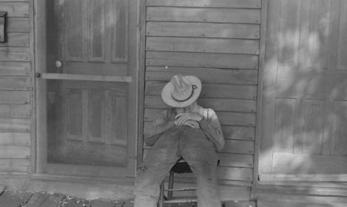 Ex-farmer resting by a house in Circleville,1938