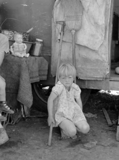 Child of white migrant worker in front of trailer home, Weslaco, Texas By Russell Lee, 1903-1986, photographer 19390101