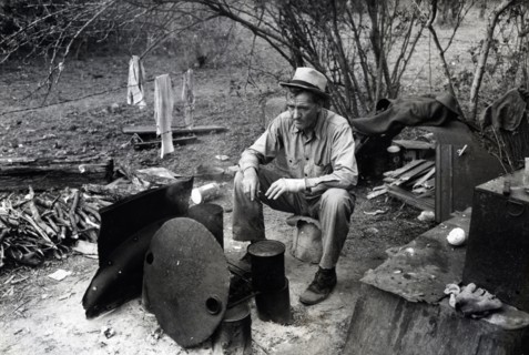 Migrant worker sitting in front of fire