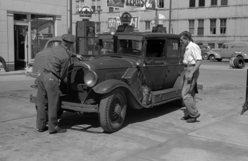 Auto of migrant fruit worker at gas station, 1940