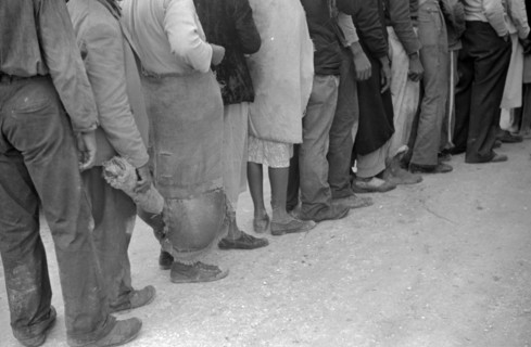 Vegetable workers, migrants, waiting after work to be paid. Near Homestead, Florida dated 19380101