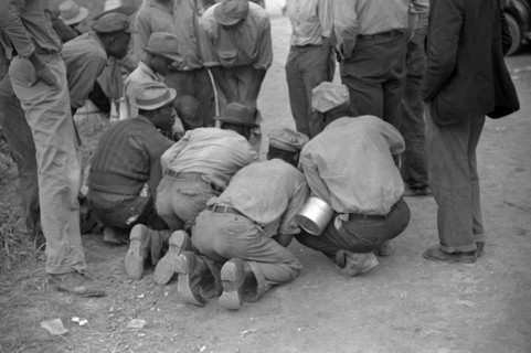 Vegetable workers, migrants, waiting after work to be paid. Near Homestead, Florida 19390101