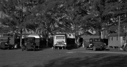 Autos and trailers encamped in a tourist camp used by migrant fruit workers, near Belle Glade, Florida 19370101