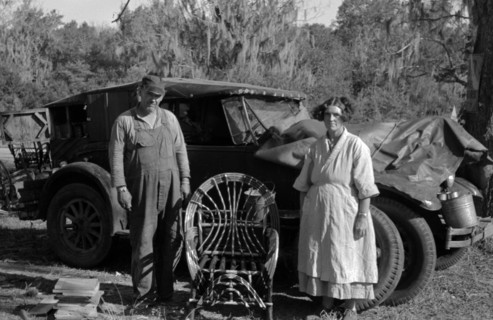 Migrant cane chair maker and wife in front of their automobile home, near Paradis, Louisiana 19380101