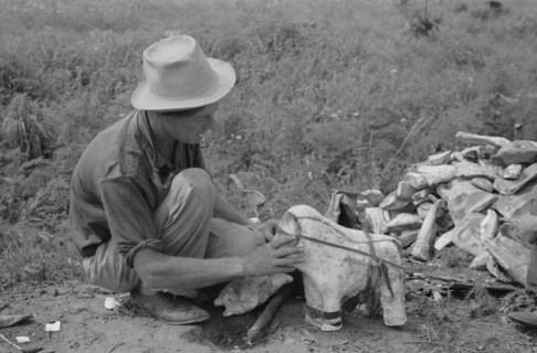 Itinerant statue maker putting together the pieces of a mould for one of his statues. 19390101