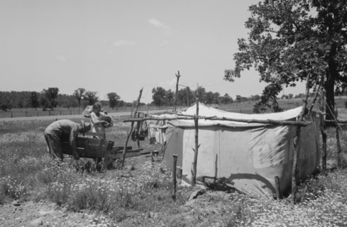 Camp of migratory workers who move along the road pushing their belongings in a cart, camped near Vian, Sequoya County, Oklahoma 19390101.