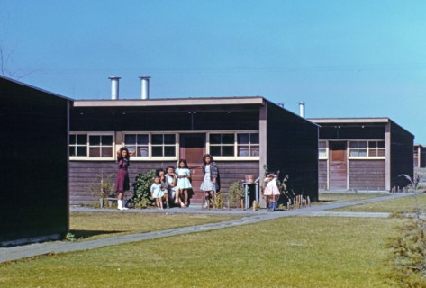 Families of migratory workers in front of their row shelters, 1942