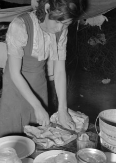 Married daughter of white migrant worker cutting salt meat for dinner. Near Harlingen, Texas 19390101b.
