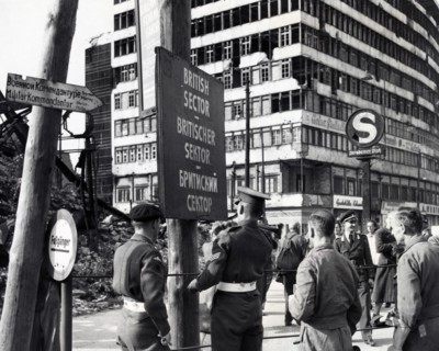 Photograph of British military police erecting a sign to mark division of the British and Russian sectors of Berlin