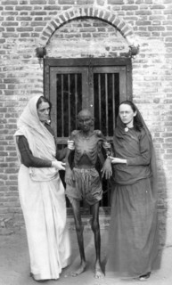 Photographic print of an emaciated famine victim standing with Miss Neil and an unidentified woman