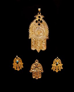 Gold palm shaped amulet, known as, the Hamsa throughout the Middle East and Africa