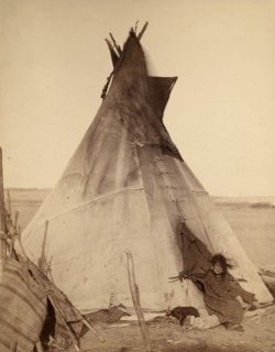 Photographic print of a young Oglala girl sitting in front of a Tipi
