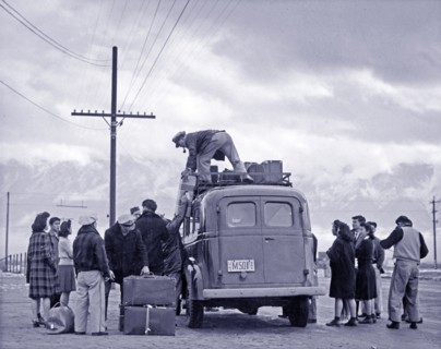 Photographic print of a loading bus leaving Manzanar for relocation