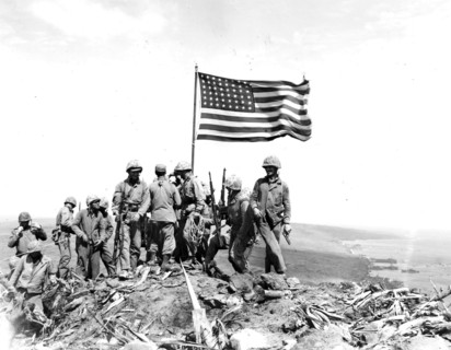 Battle of Iwo Jima. Photo taken during flag raising on volcano top.