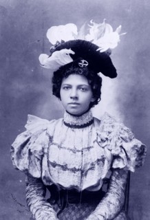 African American woman, head-and-shoulders portrait, facing front.