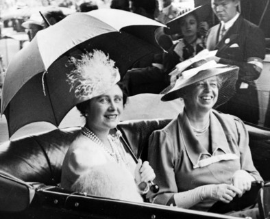 Mrs. Eleanor Roosevelt and Queen Elizabeth, holding umbrella, in automobile, leaving station for the White House.