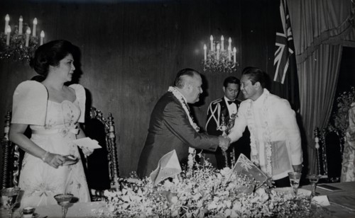 President Ferdinand Marcos greets New Zealand leader Robert Muldoon as the First Lady Imelda Marcos watches.