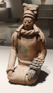 Mayan ceramic figurine of a kneeling female shaman or priestess.