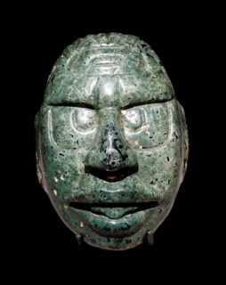 Face of the Maya Sun God carved in a green stone,