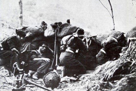 Republican soldiers shelter in a trench