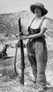 woman civilian stands guard with a rifle during the Spanish Civil War