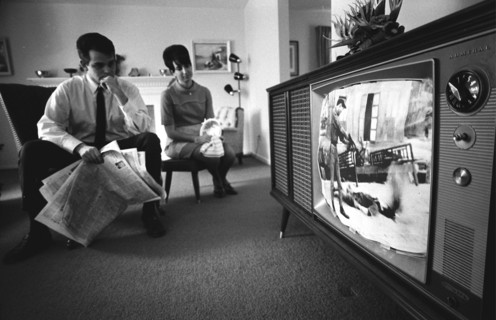 American man and woman watching news footage of the Vietnam war