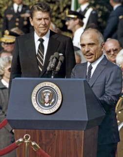Photograph of King Hussein, addressing an audience at the White House with President Ronald Reagan