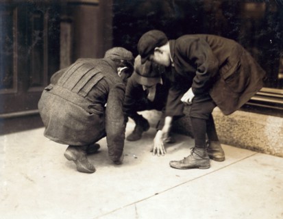 Photograph of children pitching pennies on the Main St. Fall River, Massachusetts