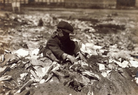 Photograph of a young scavenger going through the Trash on Pleasant Street dump