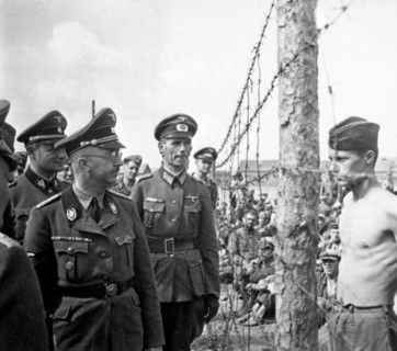 SS Chief Heinrich Himmler walks through a t prisoner of war camp for Russian prisoners of war.