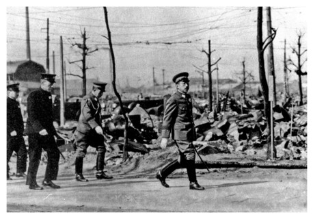 Japanese Emperor Hirohito walks through the ruins of Tokyo in the later months of World war two.