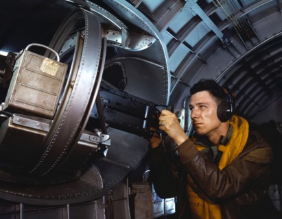 American airman using a a side machine gun of a B-17 Flying Fortress bomber