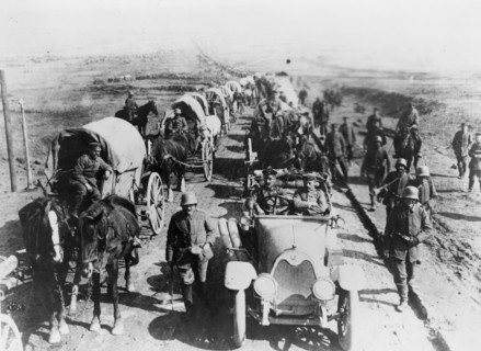 German officers in an automobile, with a convoy of wagons;World war one 1916