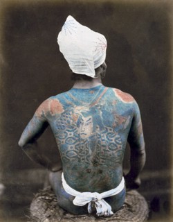 Hand-coloured photograph of a Japanese man with back tattoo Photographed by Felice Beato