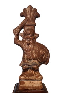 Depiction of the god Bes. Terracotta and greywacke. Ptolemaic Period