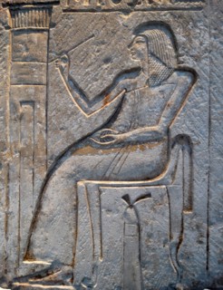 Wall relief fragment with a man decorating his tomb, Limestone. Egyptian.