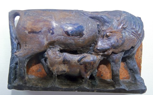 Ivory depicting a cow suckling its calf