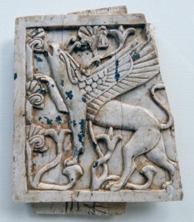 Ivory depicting a griffin eating leaves from a tree