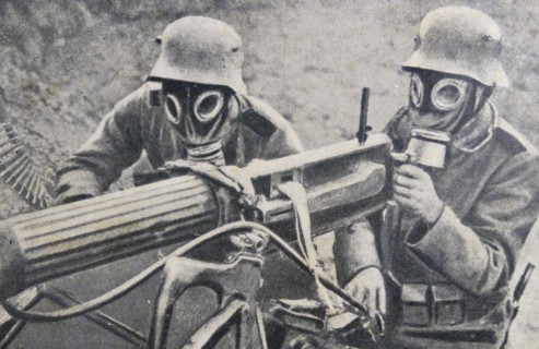 World war one: German soldiers in gas masks use a machine gun
