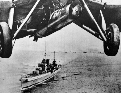 Aircraft flies above a battle cruiser of the British Royal Navy 1930's