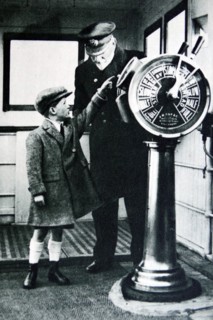 Child visiting the Bridge of an ocean liner with the captain 1936