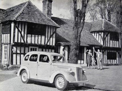Photograph of a typical 1950s family outside of their home