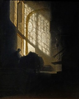 A Man seated reading at a Table in a Lofty Room'