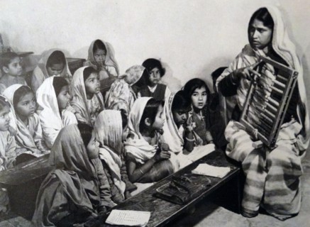 a teacher demonstrating to students how to count with an abacus