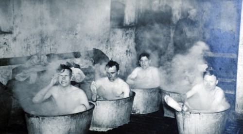 British soldiers from the Dorset shire regiment bath in metal tubs