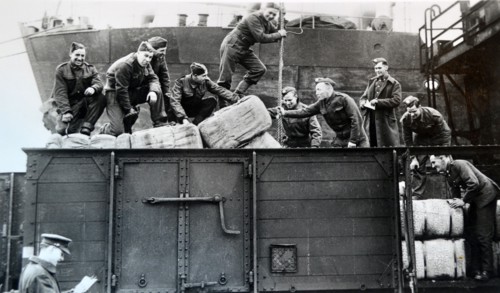 British soldiers load supplies at a railway depot in northern France, 1940
