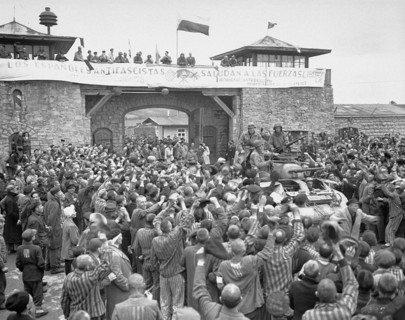Tanks of U.S. 11th Armoured Division entering the Mauthausen concentration camp;banner in Spanish reads 'Antifascist Spaniards greet the forces of liberation'. The photo was taken on 6 May 1945